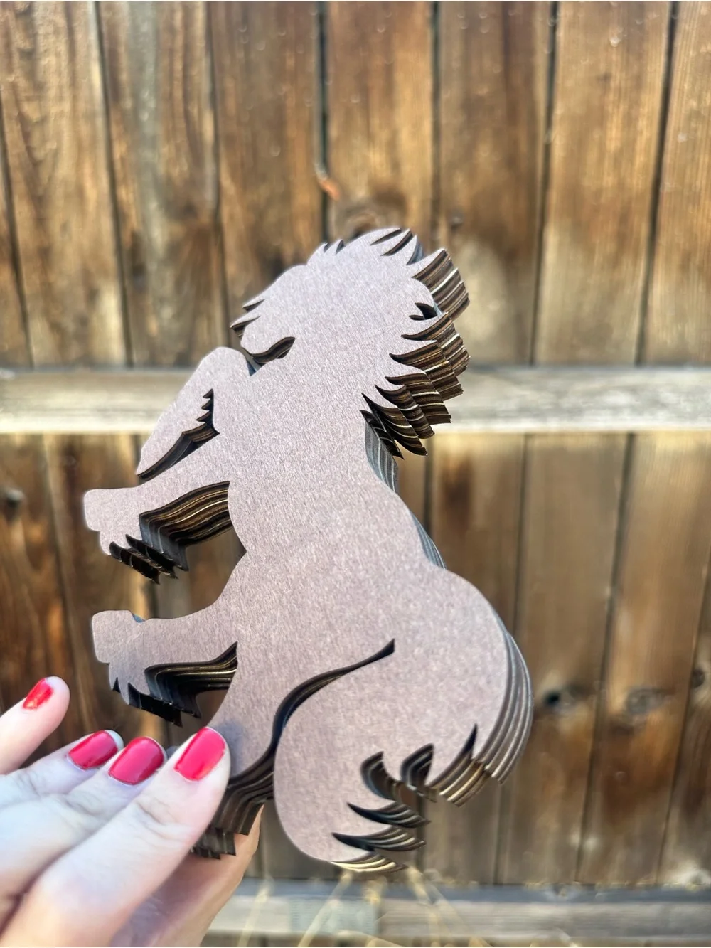 wooden horse figurine featuring a scenic mountain and forest cutout design.
